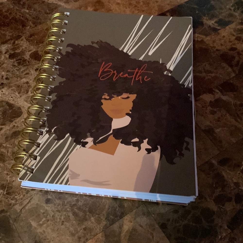 Notebook with girl on front cover with “breath” written on the front